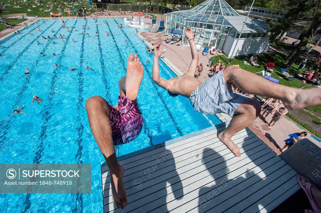 Boys diving into a public swimming pool, Moehringer Freibad, Stuttgart, Baden-Wuerttemberg, Germany, Europe