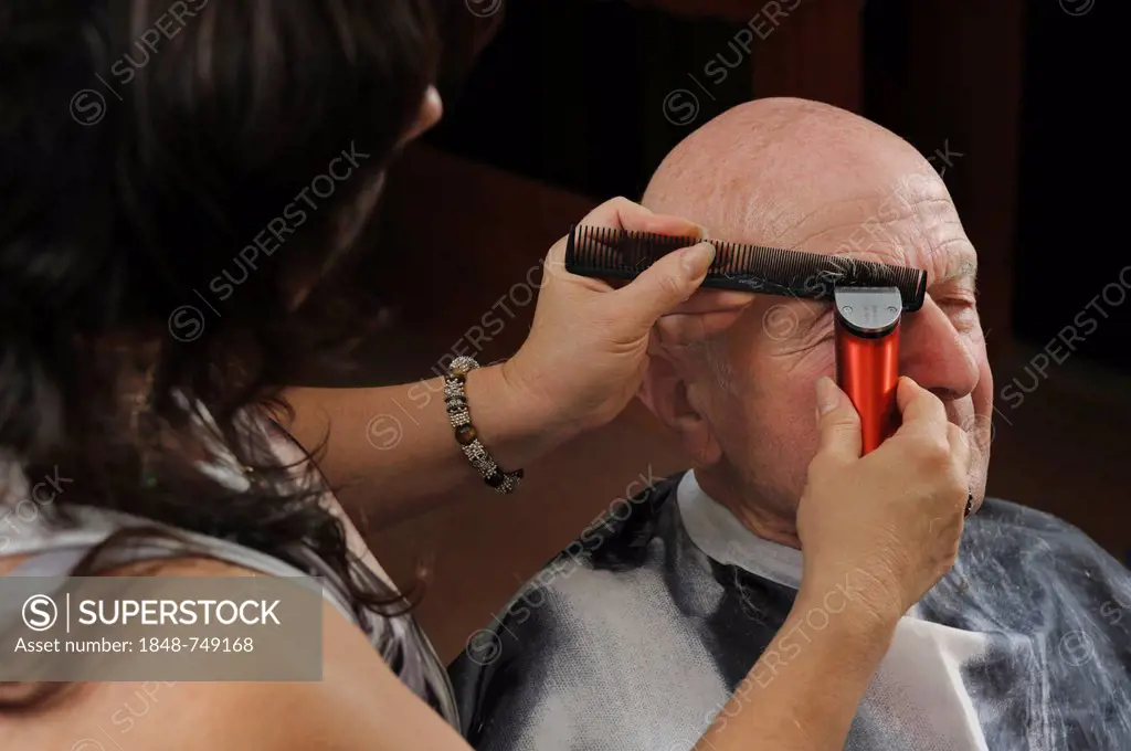 Elderly man at a hairdresser's, eyebrows cutting, Baden-Wuerttemberg, Germany, Europe