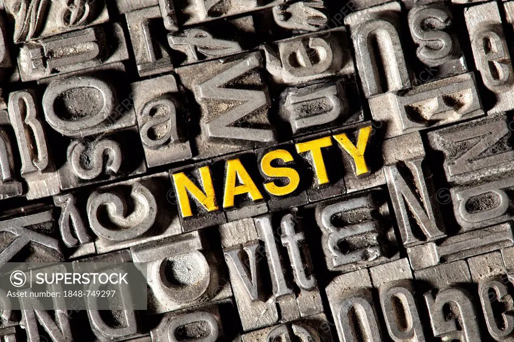 Old lead letters forming the word NASTY