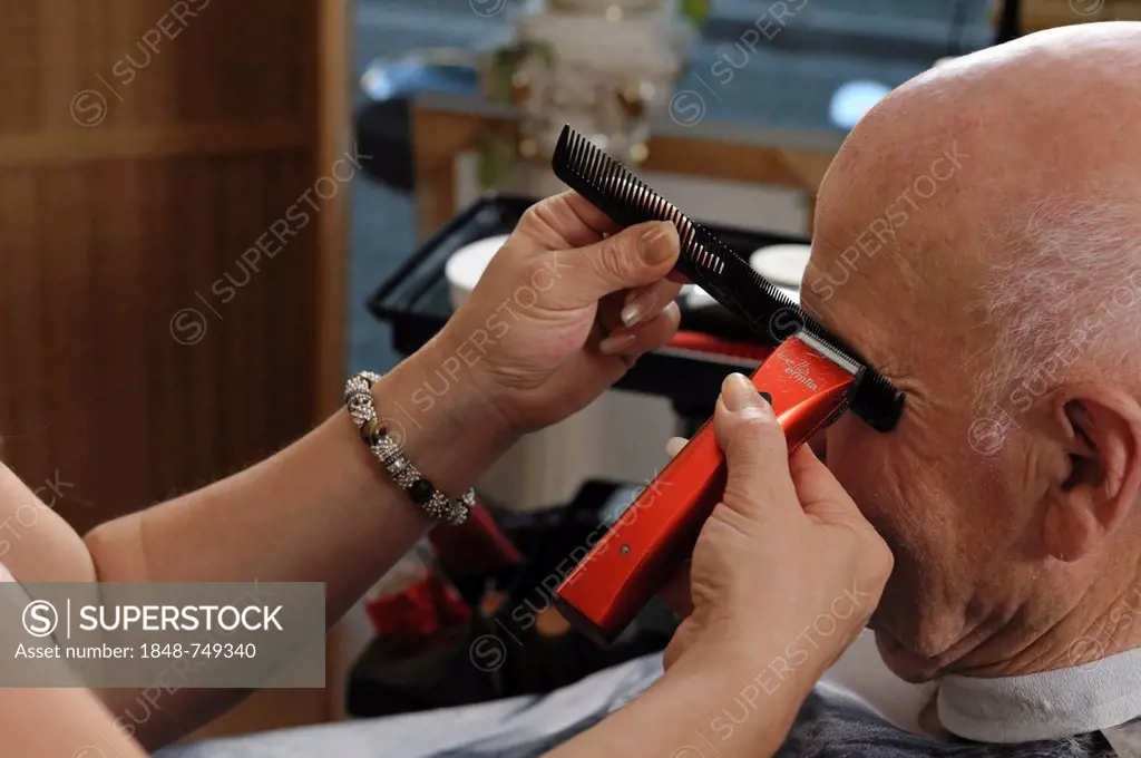 Elderly man at a hairdresser's, eyebrows cutting, Baden-Wuerttemberg, Germany, Europe
