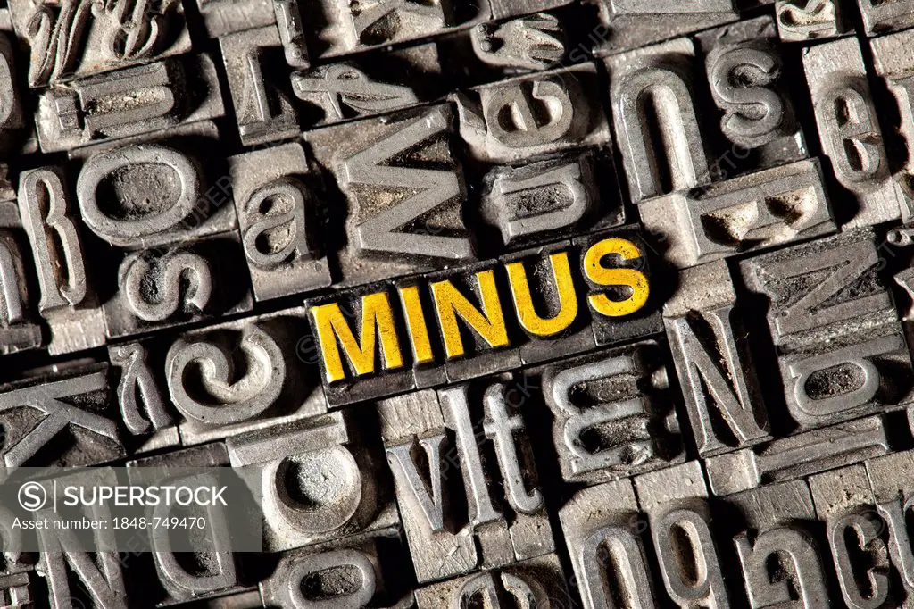 Old lead letters forming the word minus