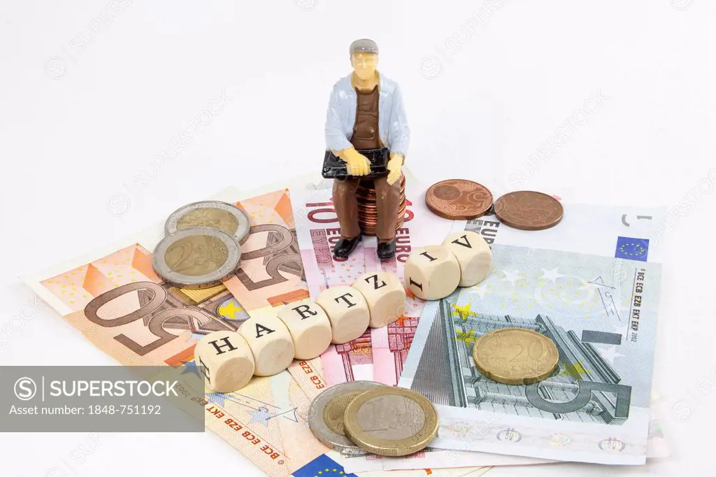 Miniature figure of a worker, Euro banknotes, letter cubes forming the word Hartz IV German income support subsidy, symbolic image for Hartz IV paymen...