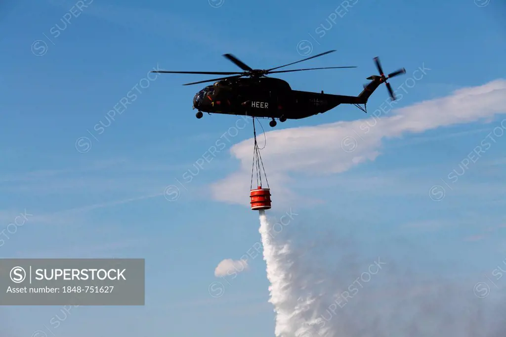 A CH-53 helicopter carrying a water container of 5000 liters