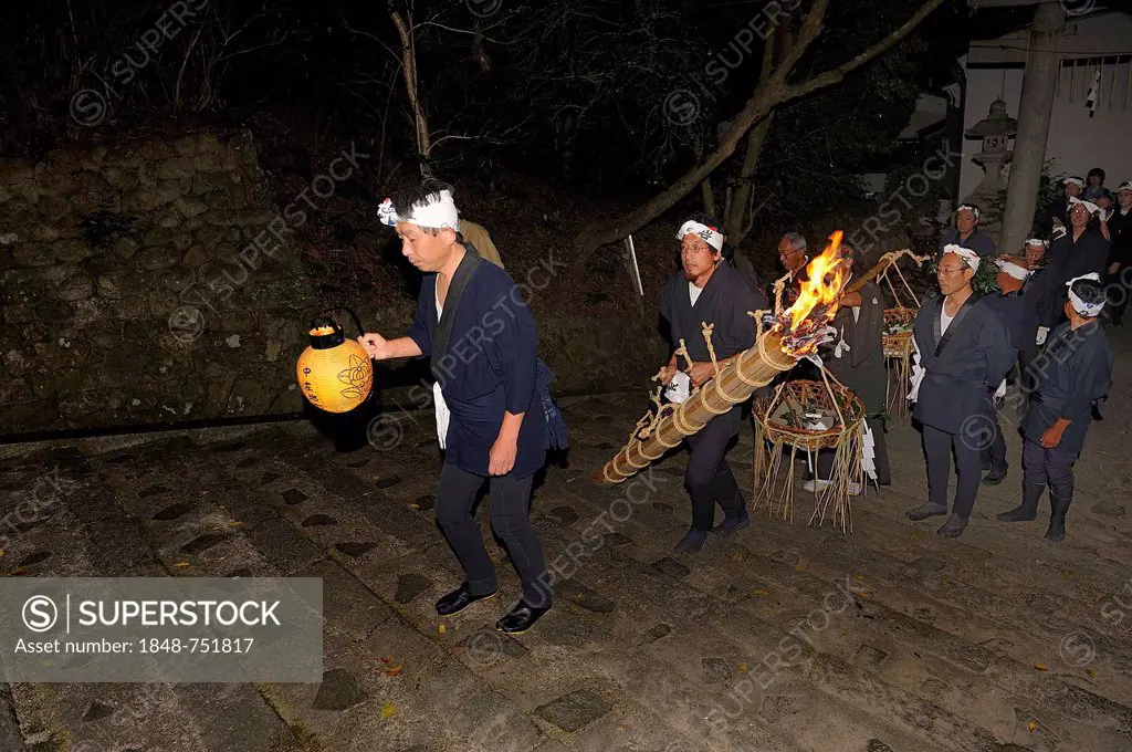 For a fire-Matsuri in Autumn torches are lit in each district and carried through the streets to the Shinto shrine, Iwakura in Kyoto, Japan, Asia