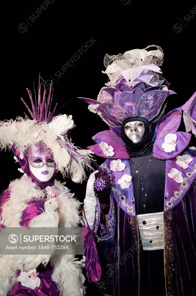 Ornate costumes and masks in purple and white, Venetian Fair, Ludwigsburg, Baden-Wuerttemberg, Germany, Europe