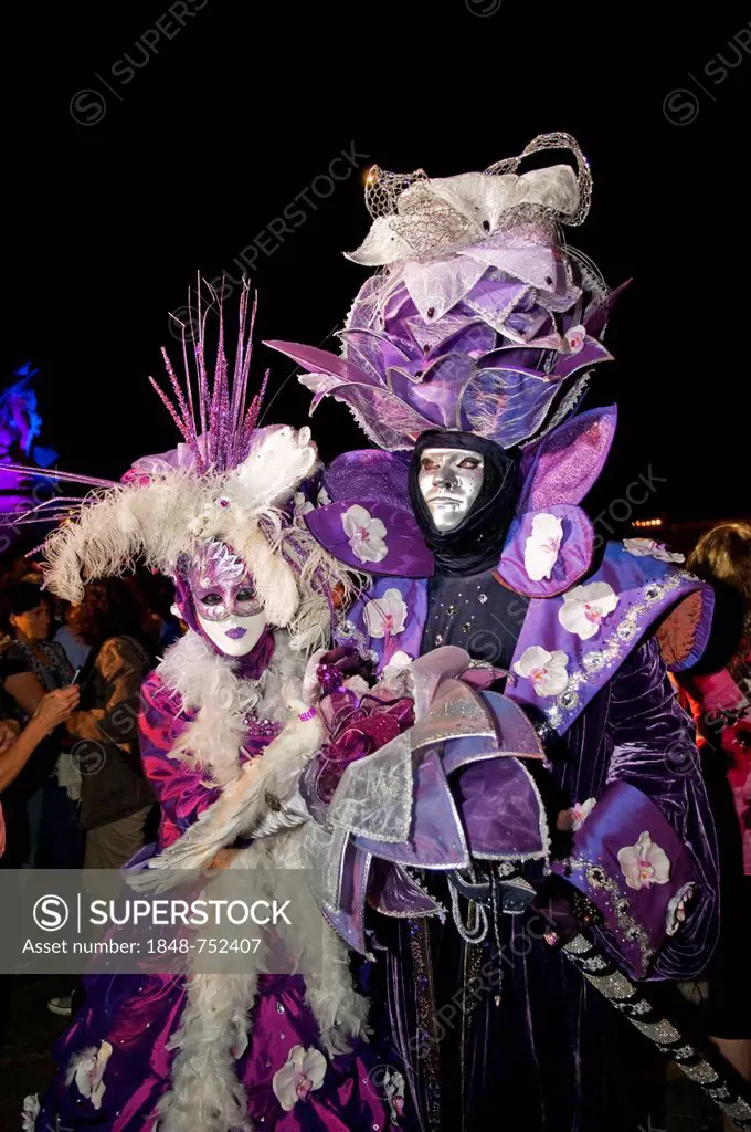 Ornate costumes and masks in purple and white, Venetian Fair, Ludwigsburg, Baden-Wuerttemberg, Germany, Europe