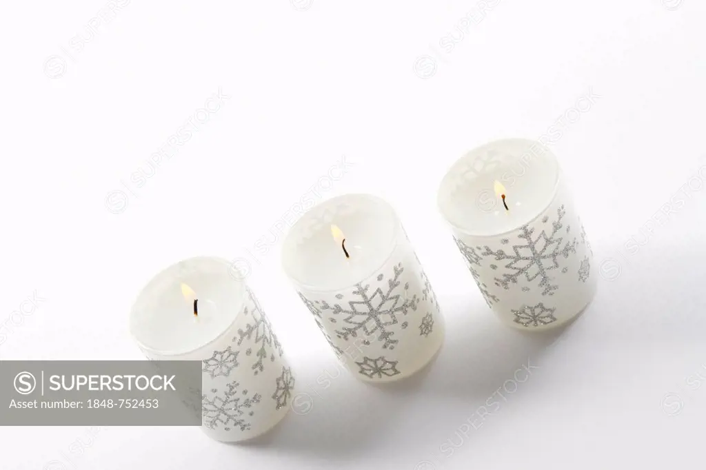 Three burning Christmas candles