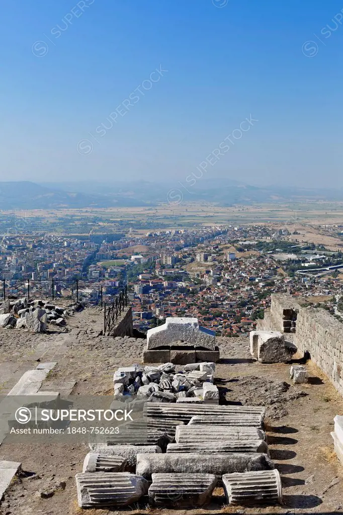 Columns at the ancient excavation site of Pergamon or Pergamum, town of Bergama at back, Izmir, western Turkey, Turkey, Asia