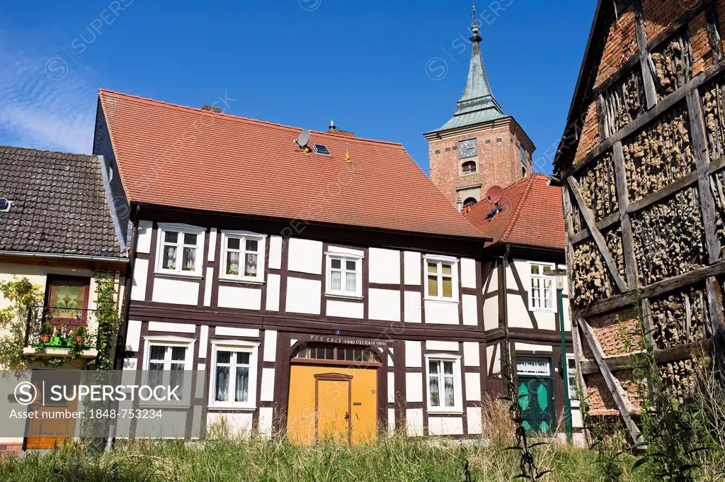 Half-timbered houses in front of the tower of St. Catherine's Church, Lenzen Elbe, Brandenburg, Germany, Europe