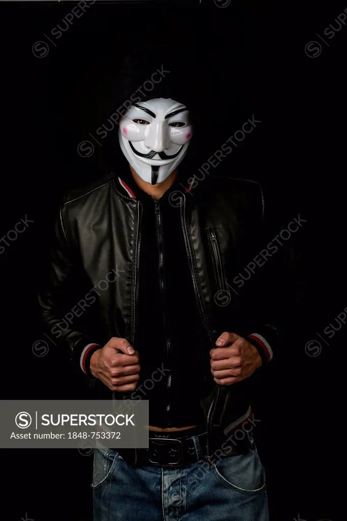 Young man wearing an anonymous mask with a hood and a black leather jacket