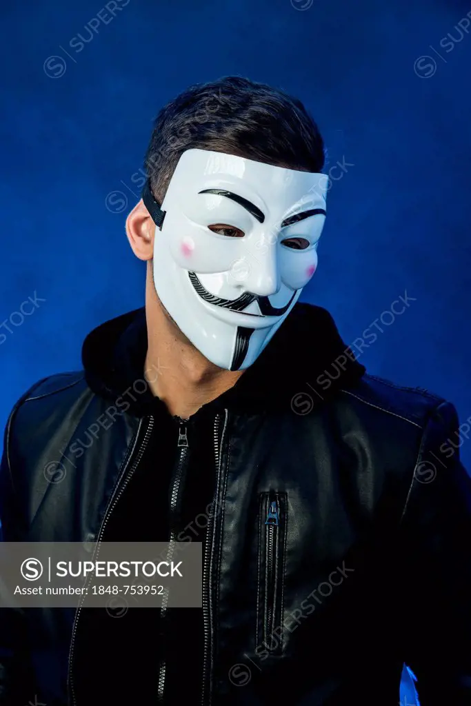 Young man wearing an anonymous mask and a black leather jacket