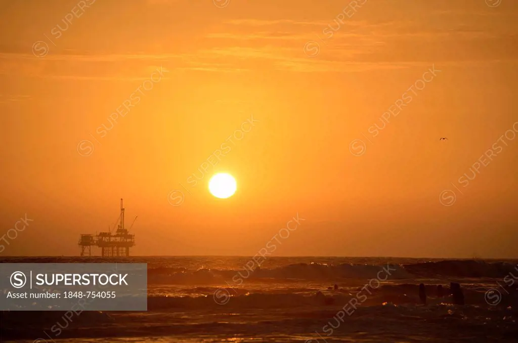 Offshore oil rig off Huntington Beach, sunset, California, United States of America, USA