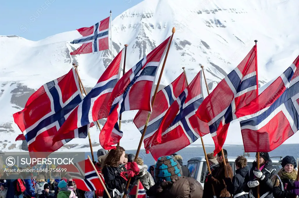 Norwegian national flags on Norwegian National Day, 17th May, being carried through Longyearbyen, Spitsbergen, Svalbard, Norway, Europe