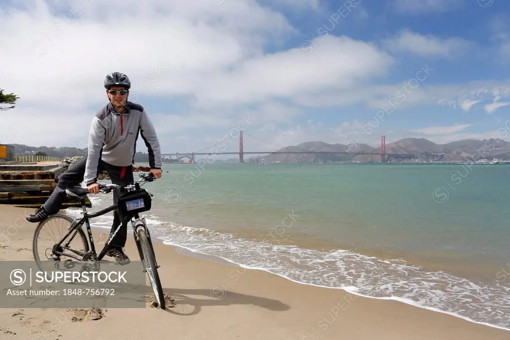 Cyclist, Golden Gate Bridge at the back, San Francisco, California, USA