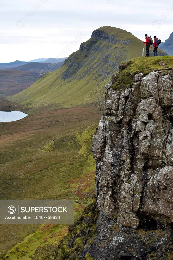 Hikers standing in the volcanic landscape, Flodigarry, Isle of Skye, Scotland, United Kingdom, Europe