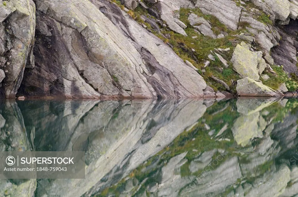 Rocks being reflected in the water, Lake Unterer Wildgerlos See, Gerlos, Austria, Europe