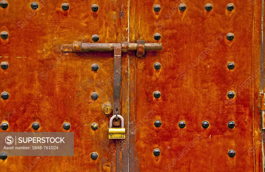 Lock and bar on an old metal door