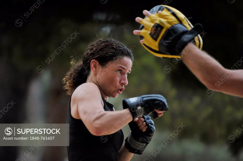 Woman doing martial arts training in a park