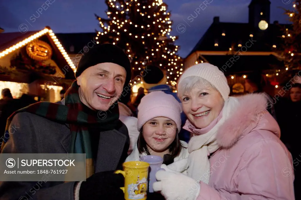 Granddaughter and Grandparents and at the Christmas market in Annaberg-Buchholz, Saxony, Germany, Europe