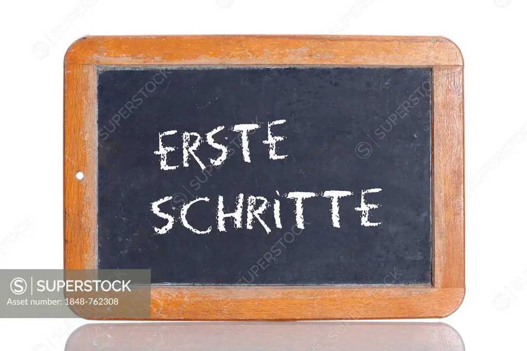 Old school blackboard with the term ERSTE SCHRITTE, German for first steps