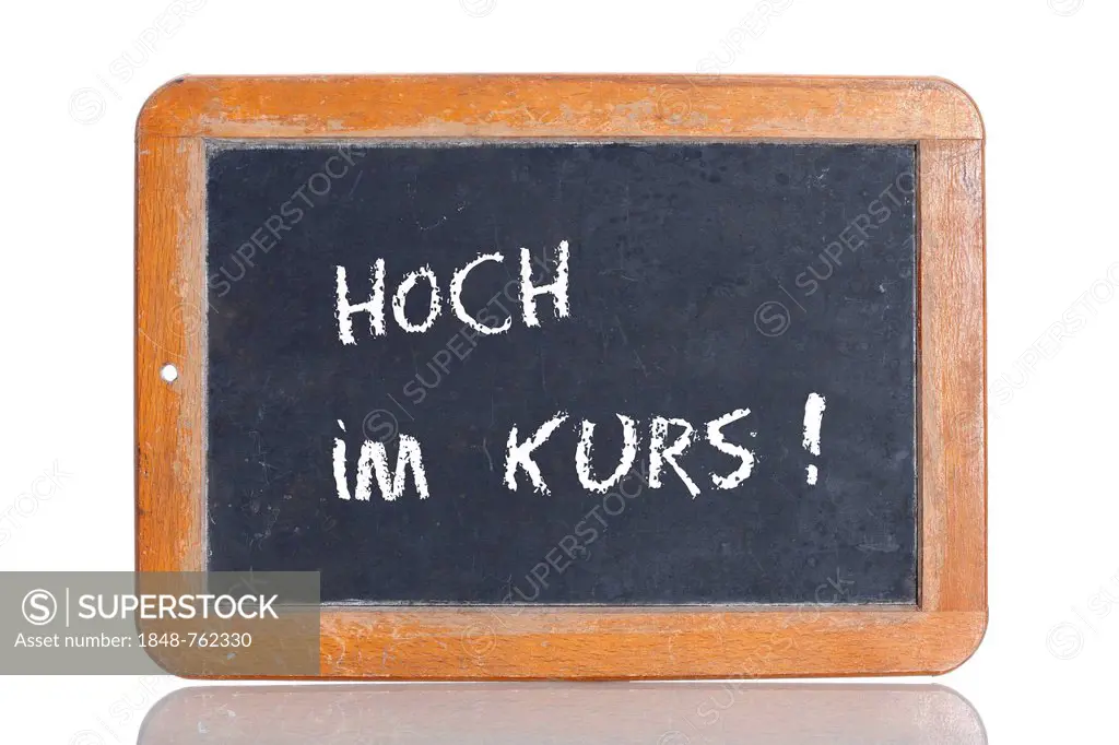 Old school blackboard with the term HOCH IM KURS, German for highly popular