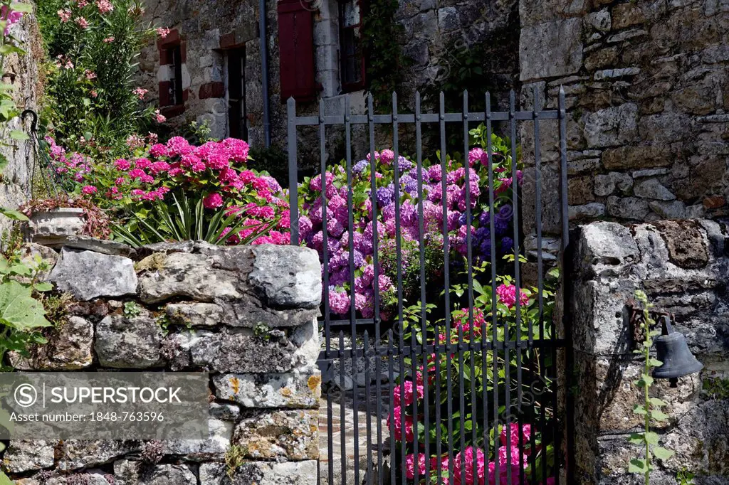 Gate, stone wall, flowers, Turenne, labelled Les Plus Beaux Villages de France, Corrèze, Limousin, France, Europe