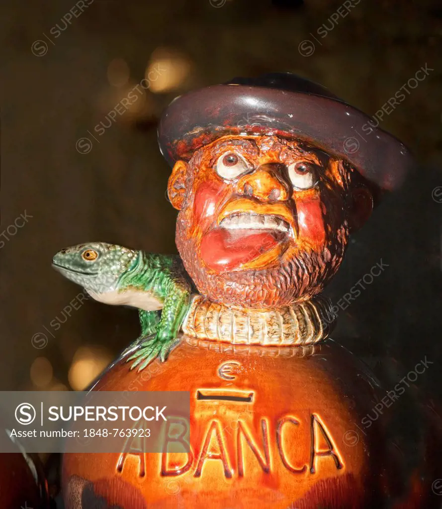 Old money box, figure being strangled by a lizard, labeled A Banca