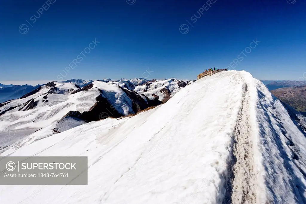 Mountain climber on the summit of Monte Cevedale, looking towards Monte Vioz, Alto Adige, Italy, Europe