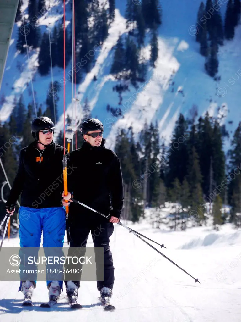 Two skiers on ski lift Fellhorn, Oberstdorf, Allgaeu, Bavaria, Germany, Europe