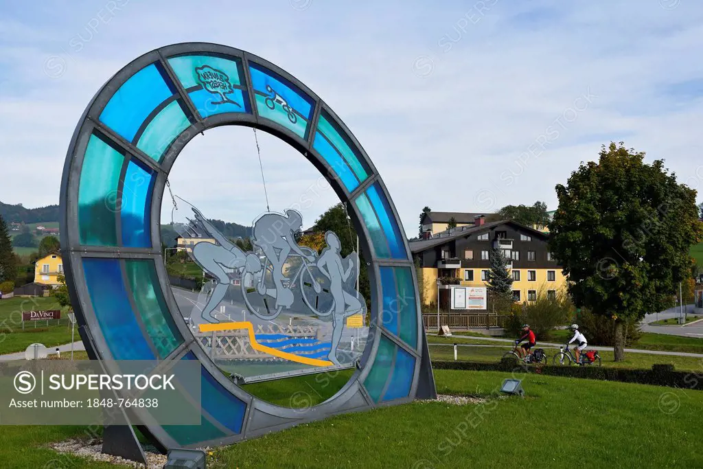 Roundabout with cyclists riding electric bicycles, Obertrum, Salzburg Lake District, Salzburg, Austria, Europe