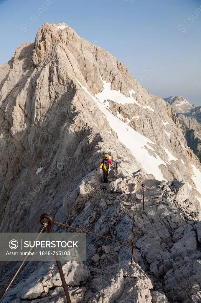 Climber climbing along a ridge, ascent along the regular route towards Triglav Mountain, Triglav National Park, Slovenia, Europe