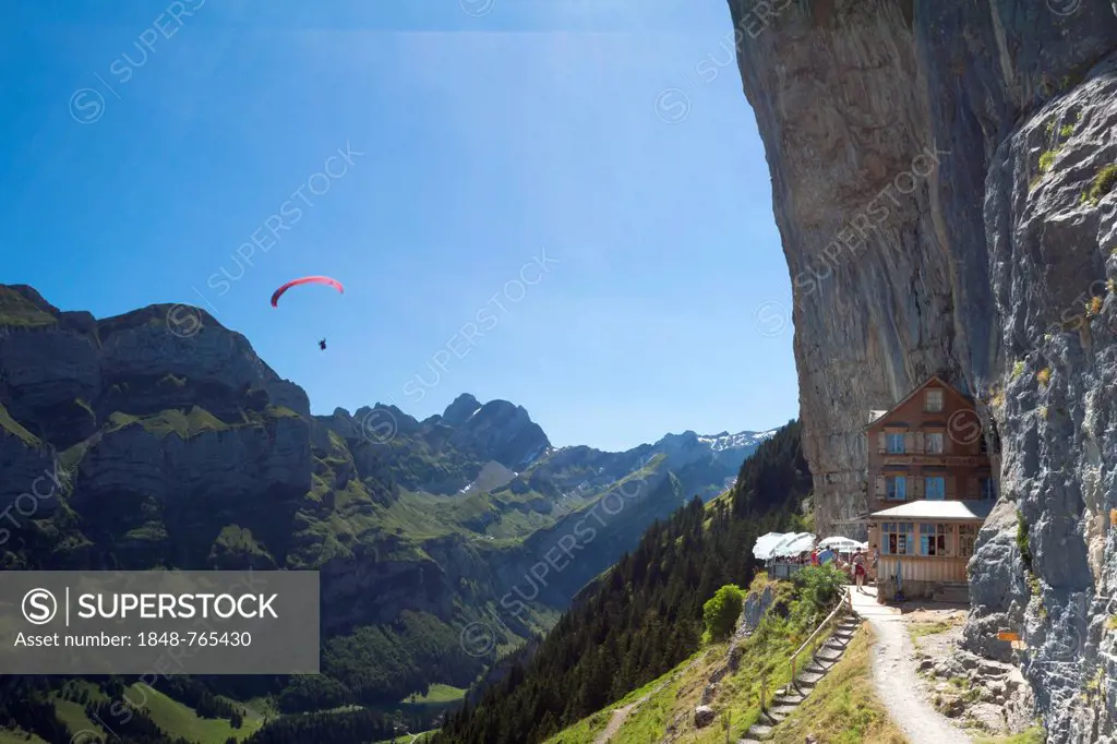 Aescher mountain inn with paragliders and a view of the Seealpsee Lake and the Meglisalp, Wasserauen, Appenzell Innerrhoden, Appenzell Inner Rhodes, S...