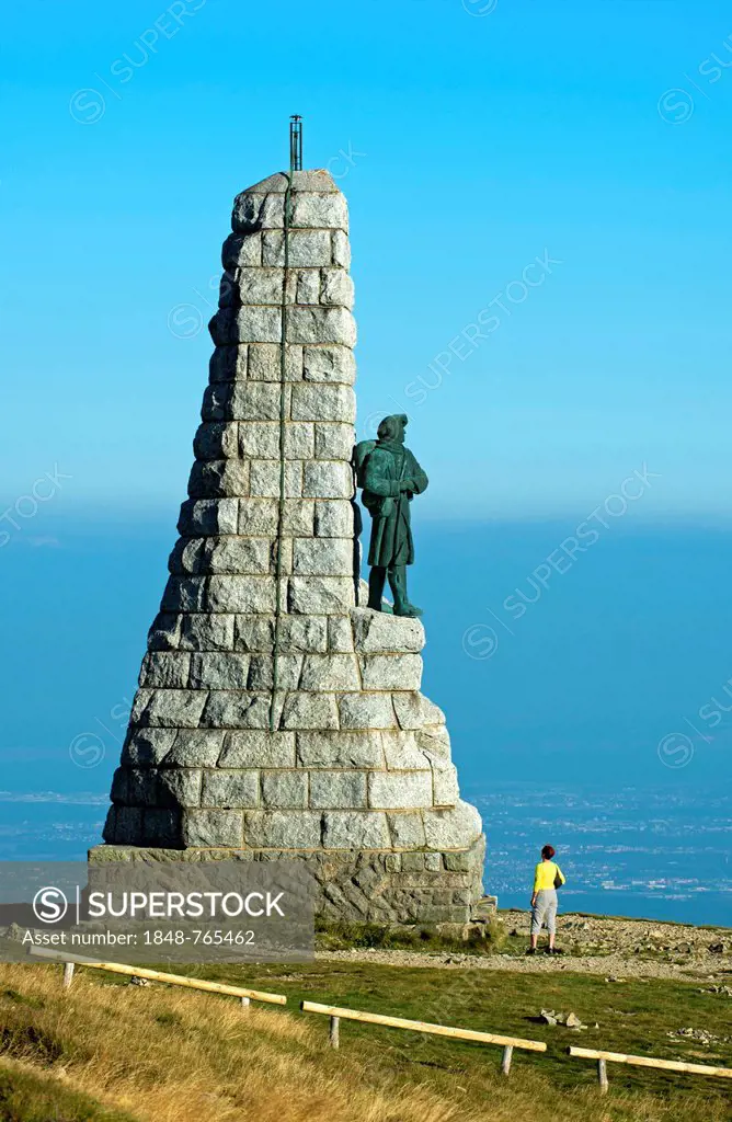 Visitor at the Monument to the Mountain Infantry Battalion Blue Devils, Diables bleus, on the summit of Grand Ballon, above the Rhine Valley, Natural ...