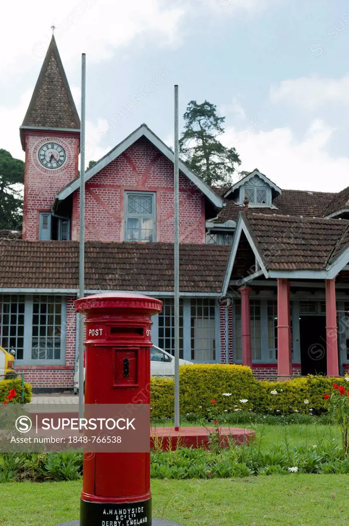 Old post office building, red pillar post box, red brick Victorian-style house, British colonial heritage