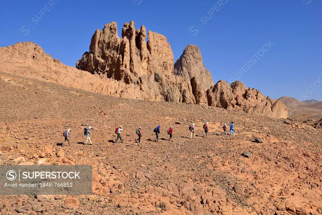 Group of hikers at the diatreme, volcanic pipe, of Aouknet mountain