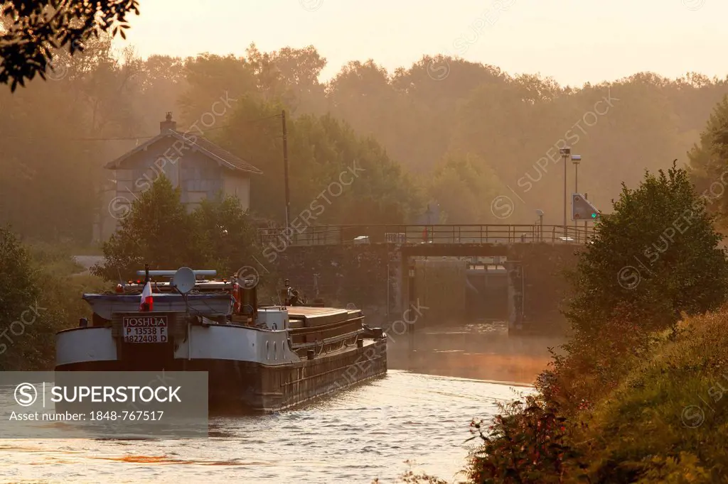 Early morning on the Canal des Vosges, formerly Canal de l'Est, freighter Joshua at lock No. 41