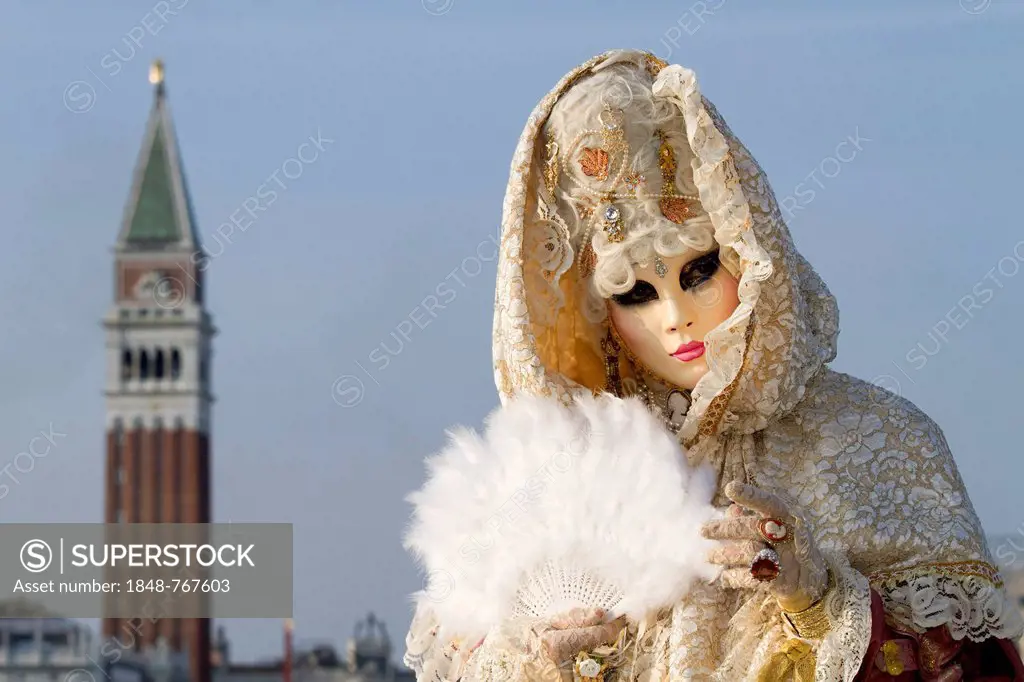 Carnival in Venice, Venetian mask and a fanciful costume, Campanile tower at back