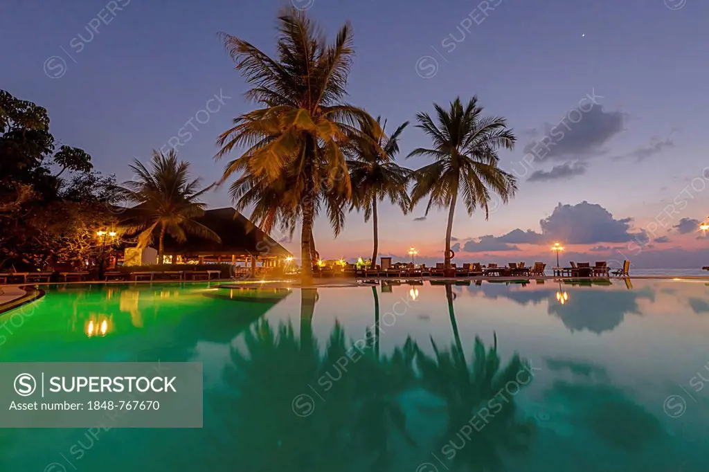 Restaurant and pool area of Paradise Island at dusk