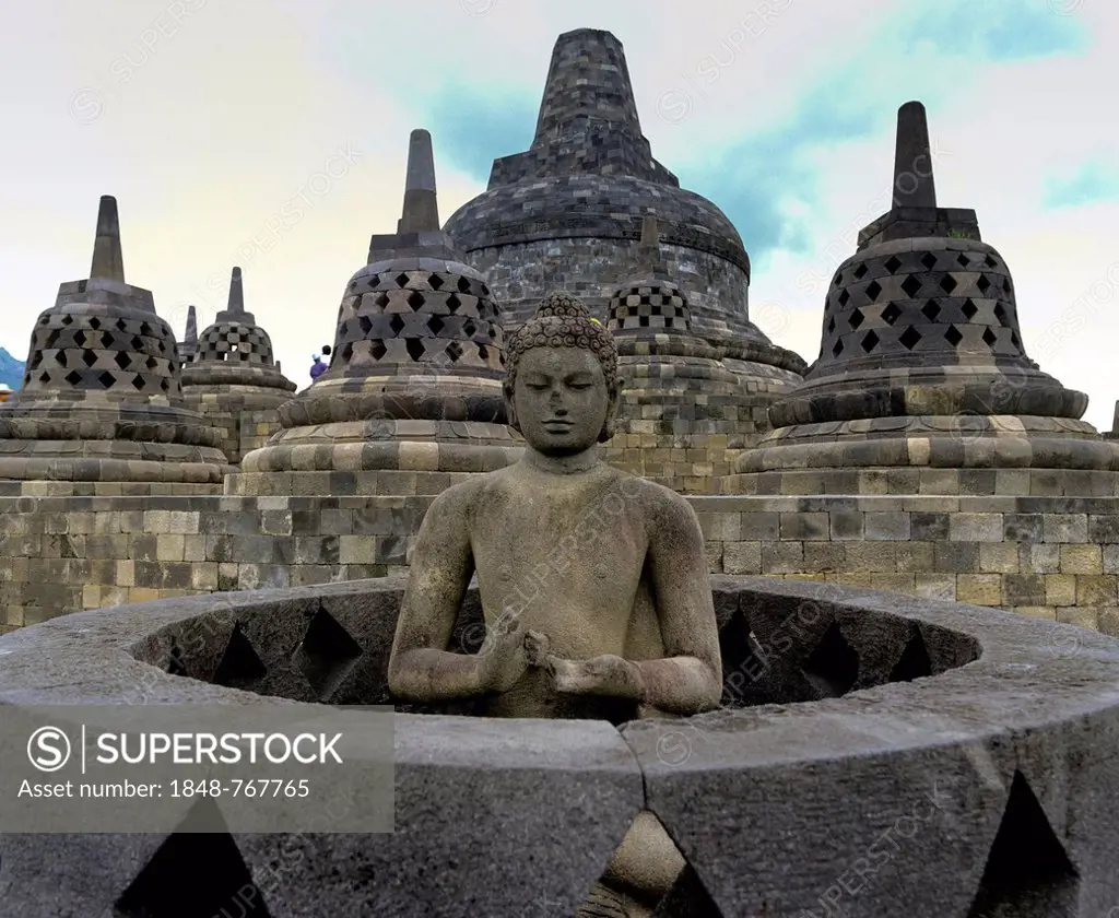 Exposed Buddha statue in the temple complex of Borobudur, stupas, UNESCO World Cultural Heritage Site