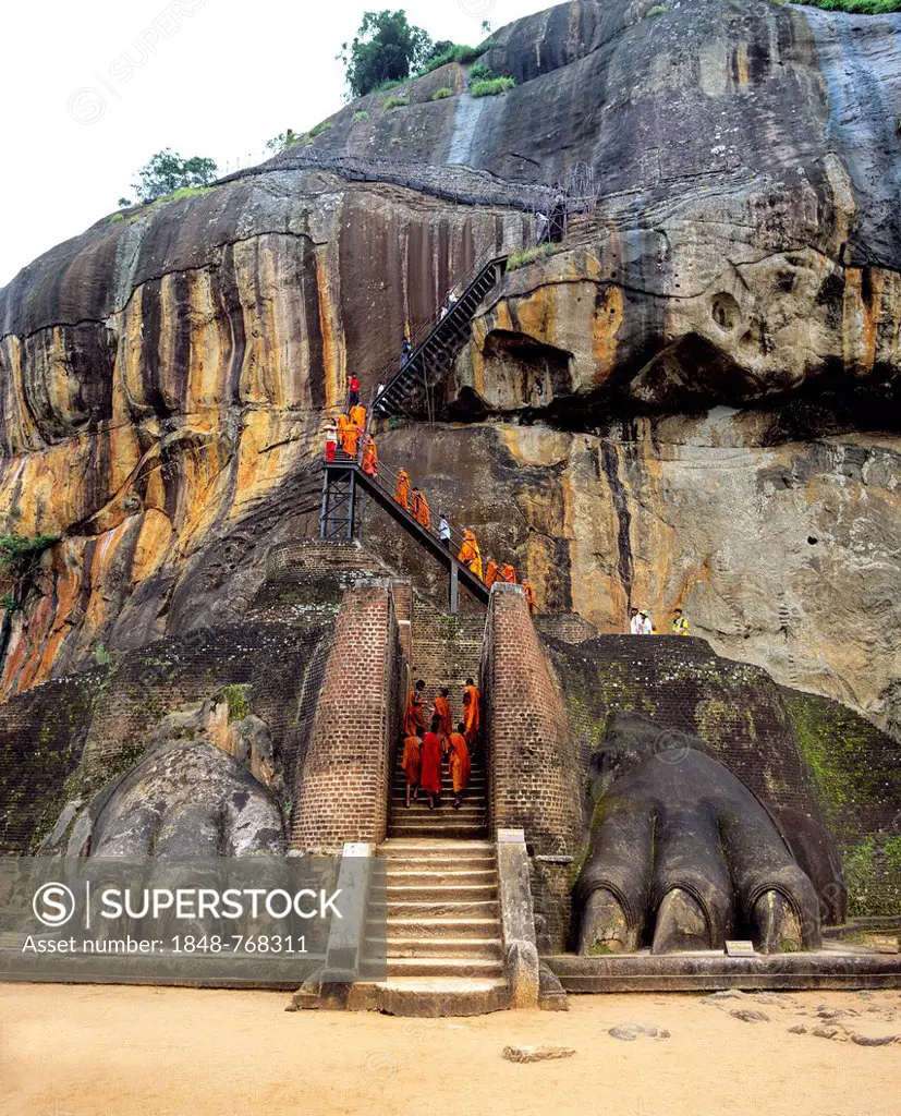 Monks at the Lion Staircase of the Rock of Sigiriya, Lion Rock, column of rock of an eroded volcano, UNESCO World Heritage Site