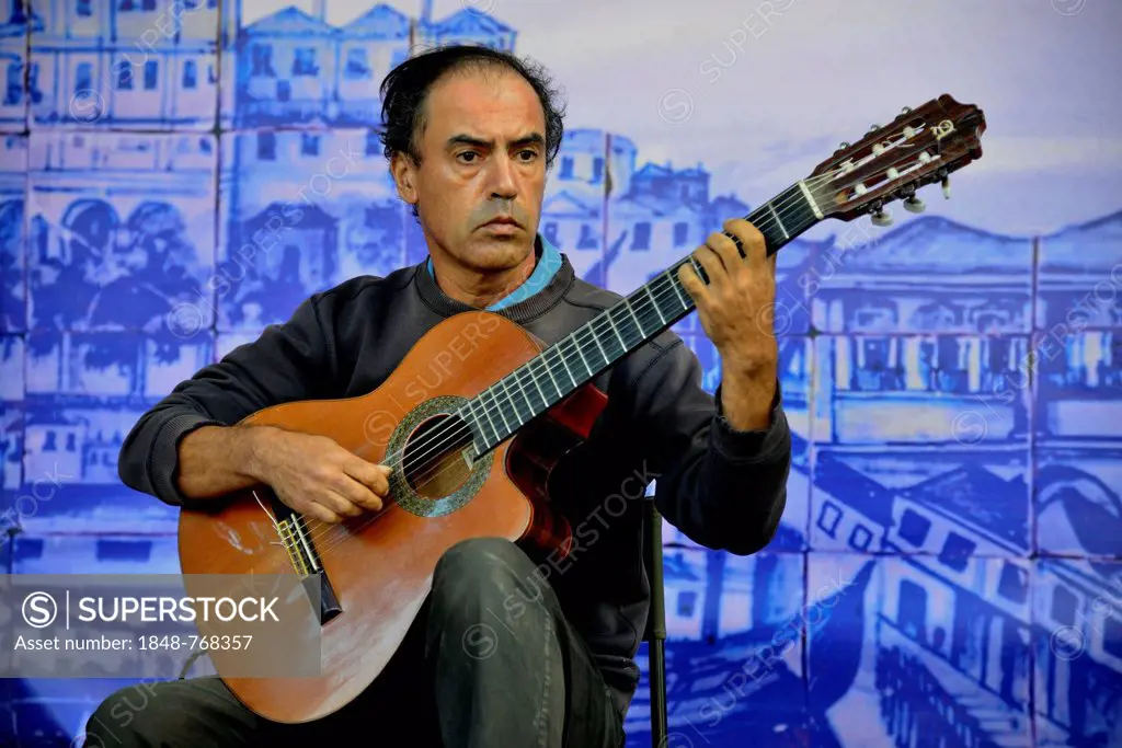Fado musician performing at a concert in Castelo de Sao Jorge Castle