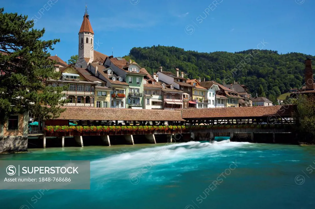 View over the Aare River and the old lock towards the historic town centre with the town church