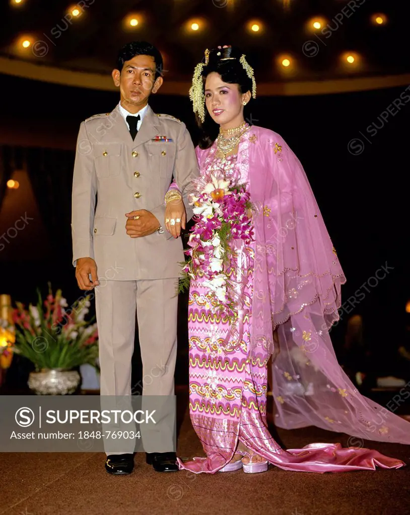 Bridal couple, groom wearing a military uniform, bride wearing traditional costume, wedding