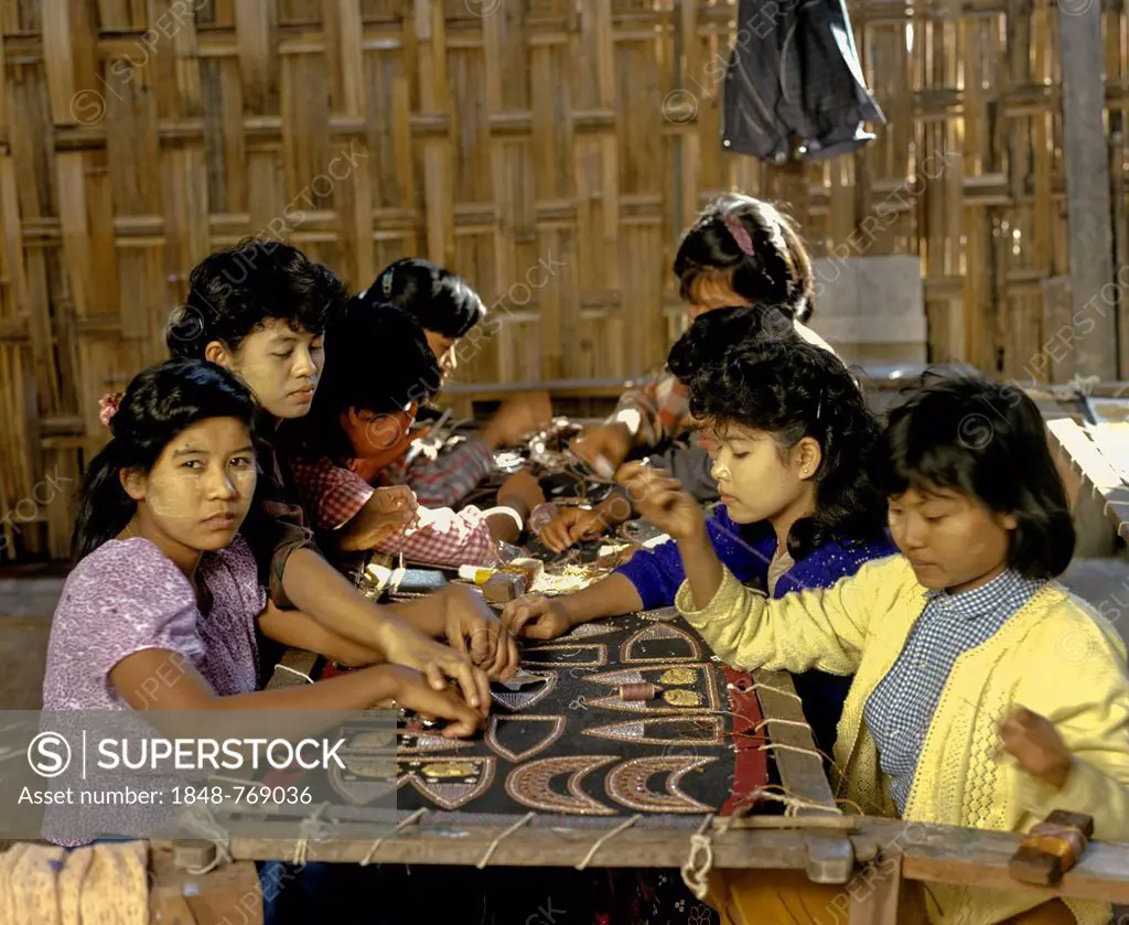 Child labour, young girls with thanaka paste on their faces at work