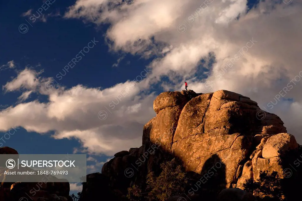 Climber on top of a rock