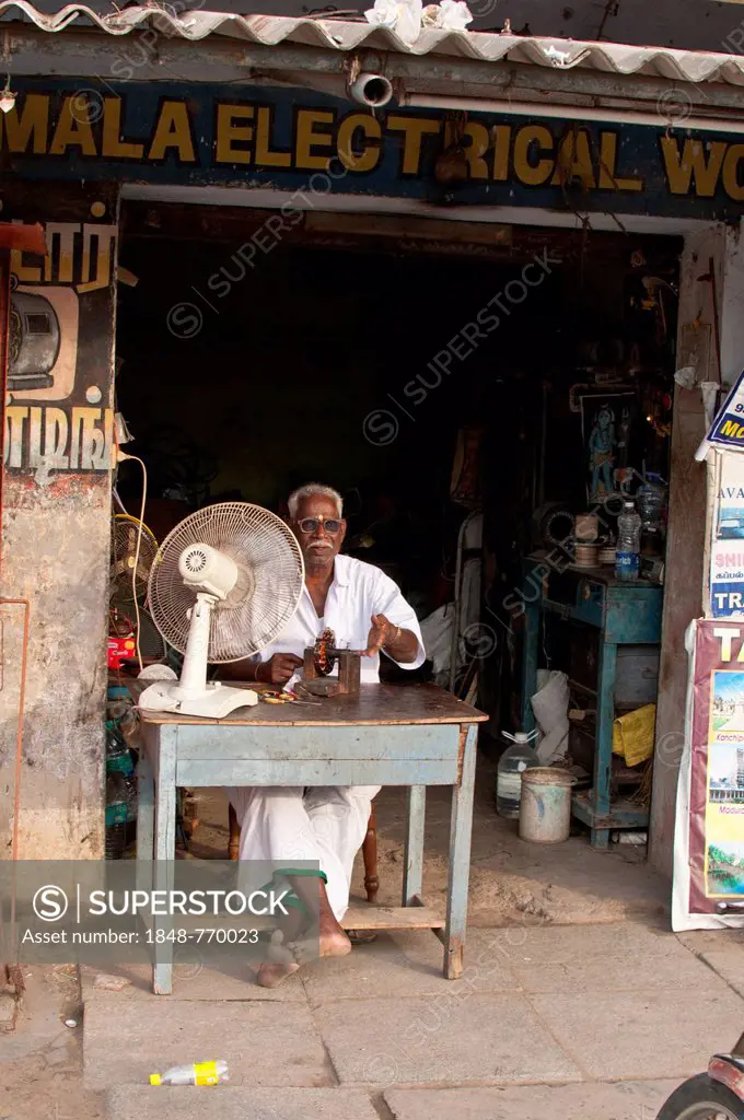 Electrician in front of his business