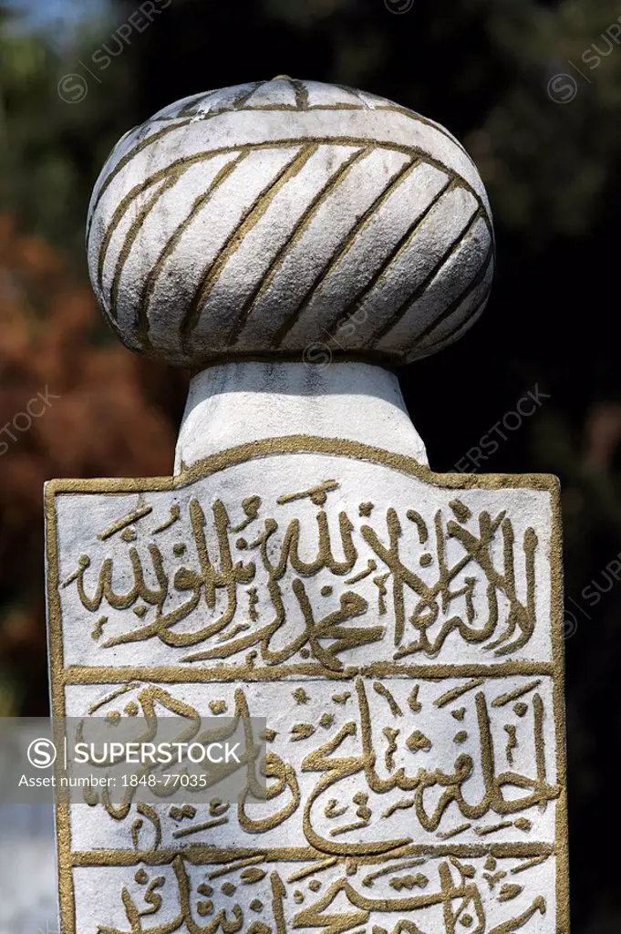 Traditional Muslim tombstone with a stylized turban and Arabic characters, Eyuep village, Golden Horn, Istanbul, Turkey