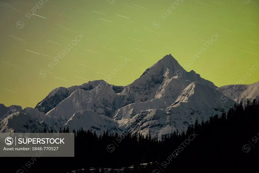 Mt. Gilbert, 9,035 foot, in the Chugach Range, lit by the glow of the northern lights, aurora borealis in the north and a new moon in the west