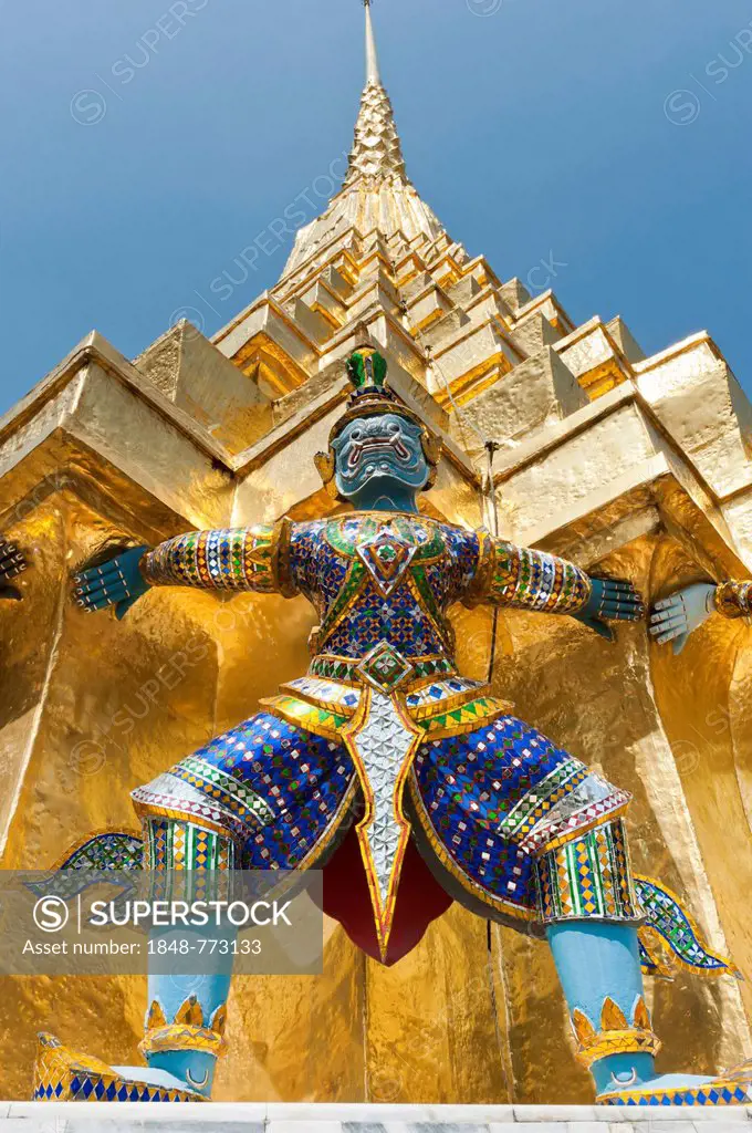 Guardian statue at the base of a golden chedi, Wat Phra Kaeo or Wat Phra Kaew Temple, Royal Palace