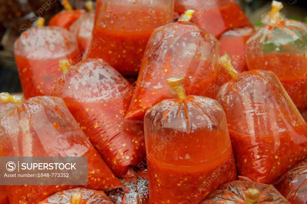 Chili sauce packed in plastic bags, at a market